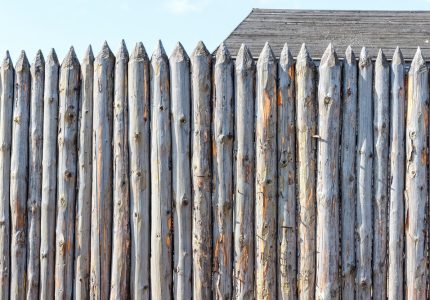 Ancient fence from trunks of trees. Protection against enemies in olden days