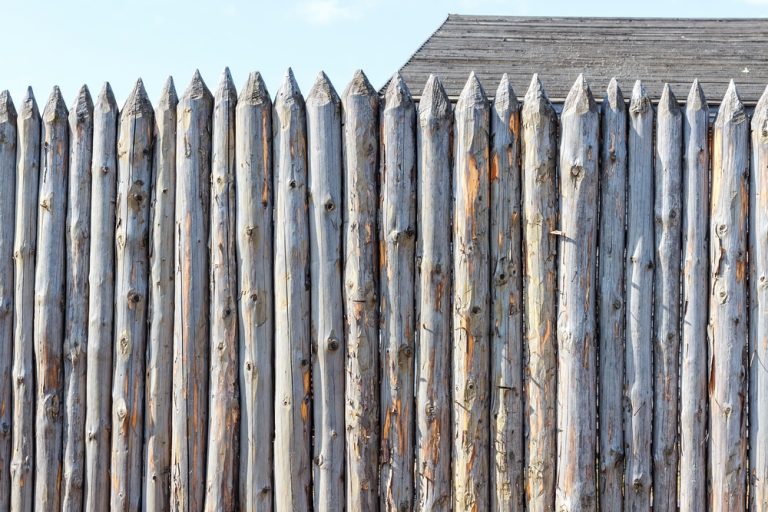 Ancient fence from trunks of trees. Protection against enemies in olden days