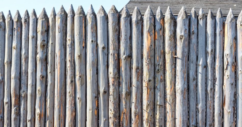 Ancient fence from trunks of trees. Protection against enemies in olden days