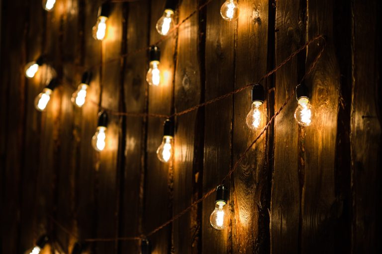 Designer light bulbs on dark wooden background.